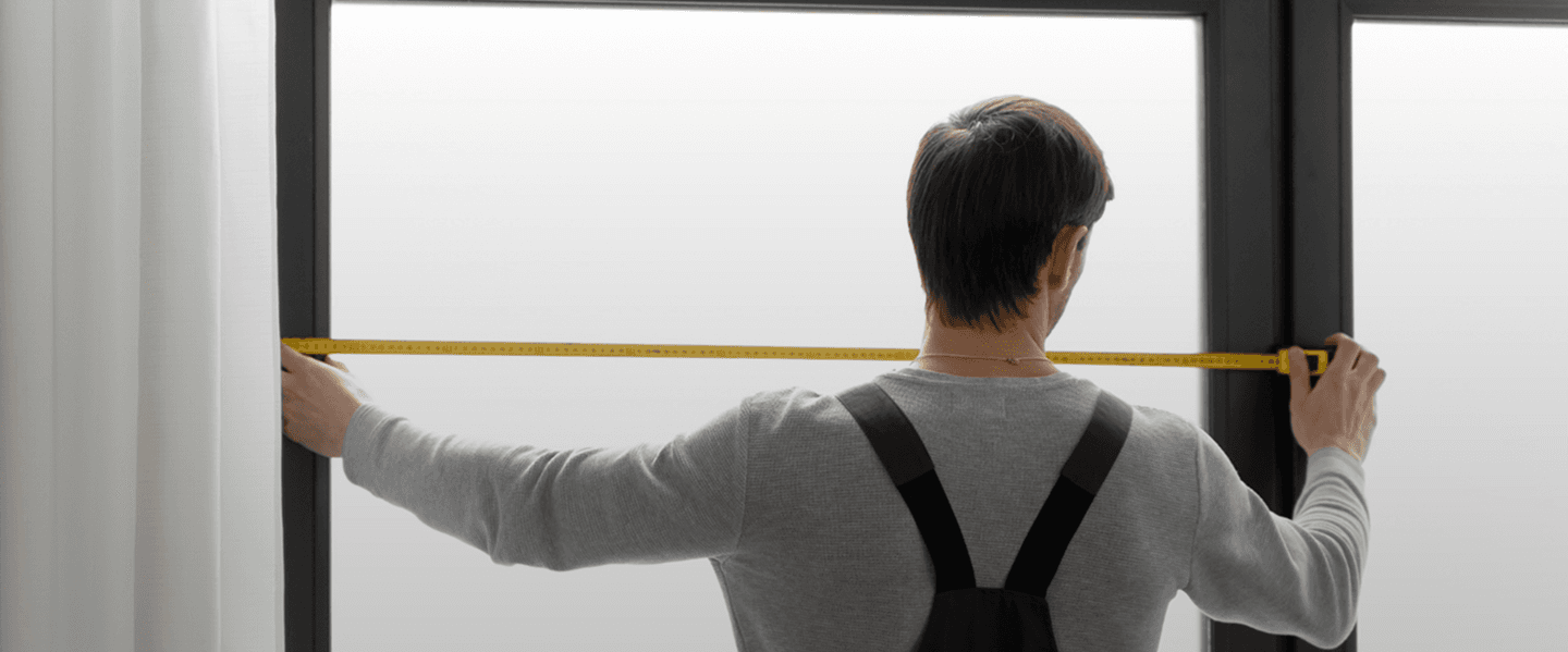 Person measuring window for curtain installation